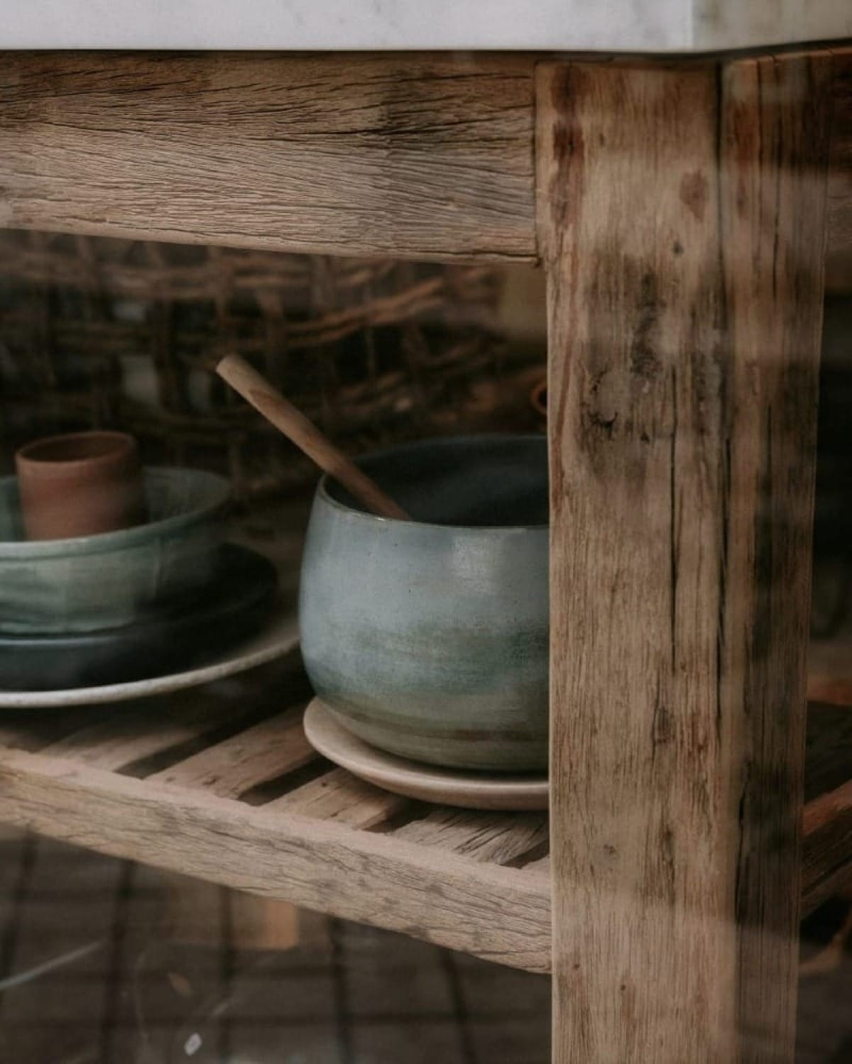 Reflection in glass contrasted with the scene behind it, illustrating the difference between surface appearance and underlying reality.