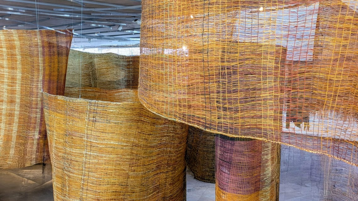 Indigenous Australian fishing fence suspended in museum atrium, demonstrating cultural reorganization | The Vantage Room